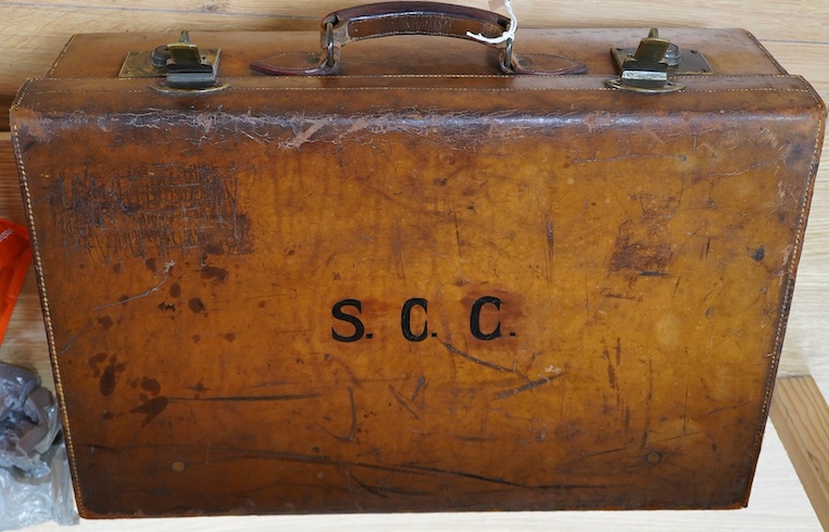 An early 20th century J. C. Vickery tan leather suitcase with green silk lining, initials stamped S.C.C. 60.5cm long, 39cm high. Condition - worn